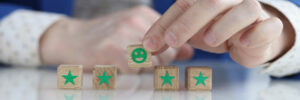 client-is-holding-smiling-smiley-face-wooden-cube-recommendation-feedback-testimonial