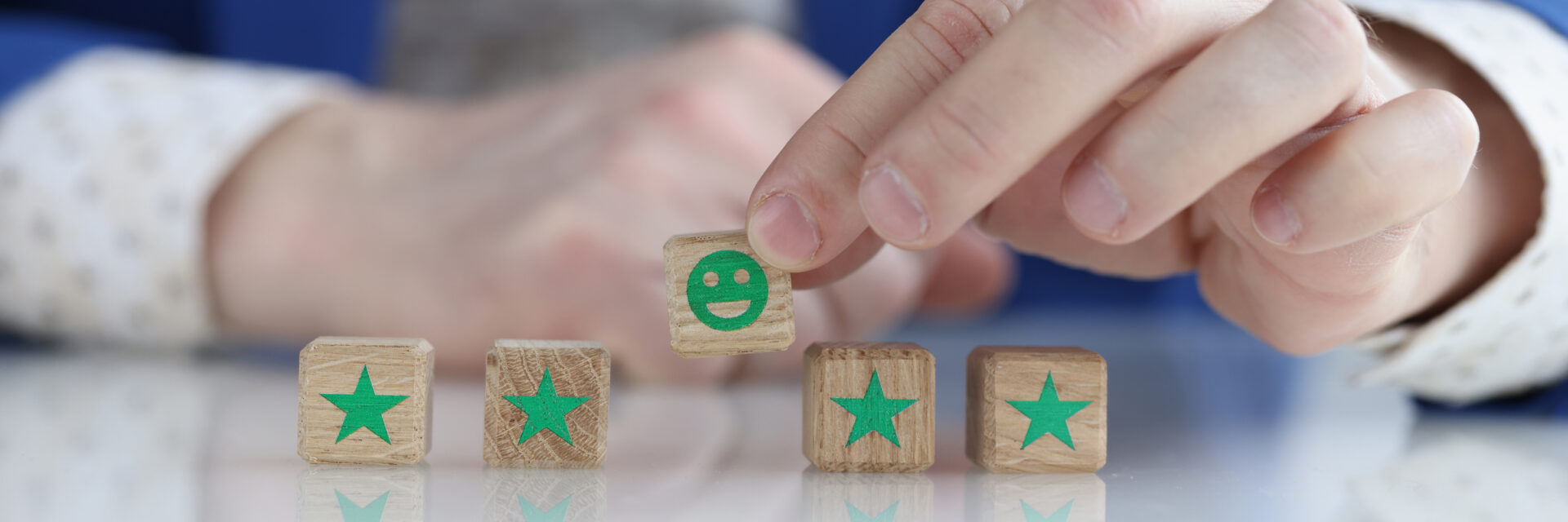 client-is-holding-smiling-smiley-face-wooden-cube-recommendation-feedback-testimonial